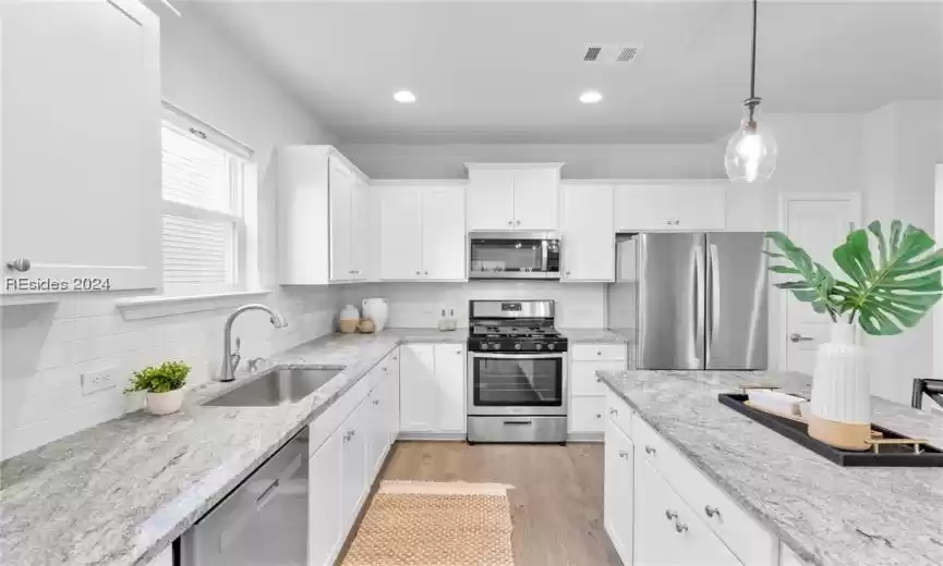 Beautiful kitchen with plenty of counters & island for food prep and cooking
