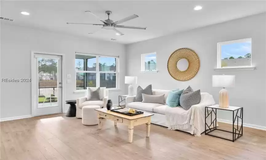 Living area with Luxury LVP wood-style flooring and ceiling fan