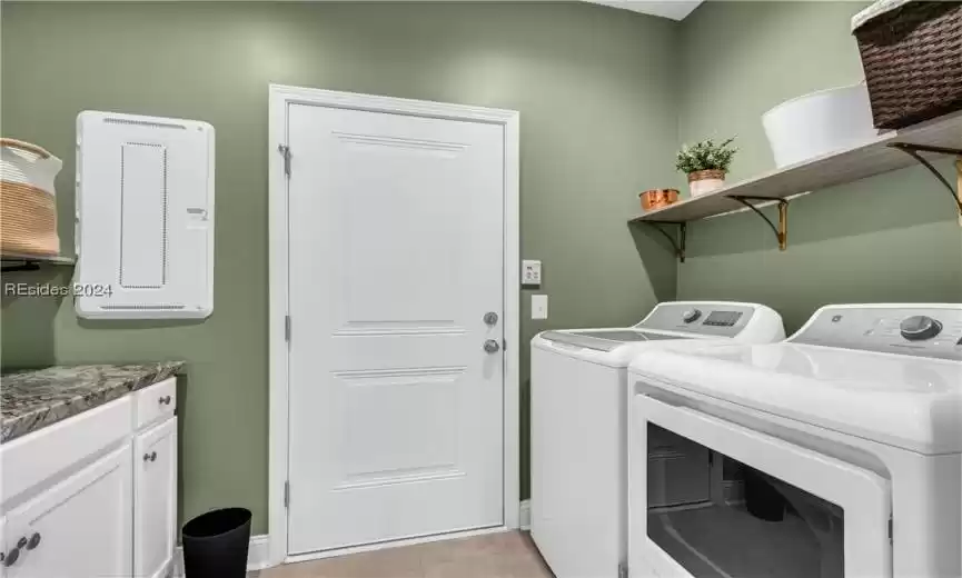 Gas dryer. Washer and cabinetry w counter.