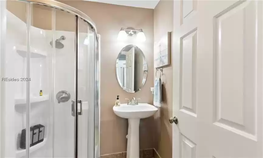 Bathroom with sink and a shower with door