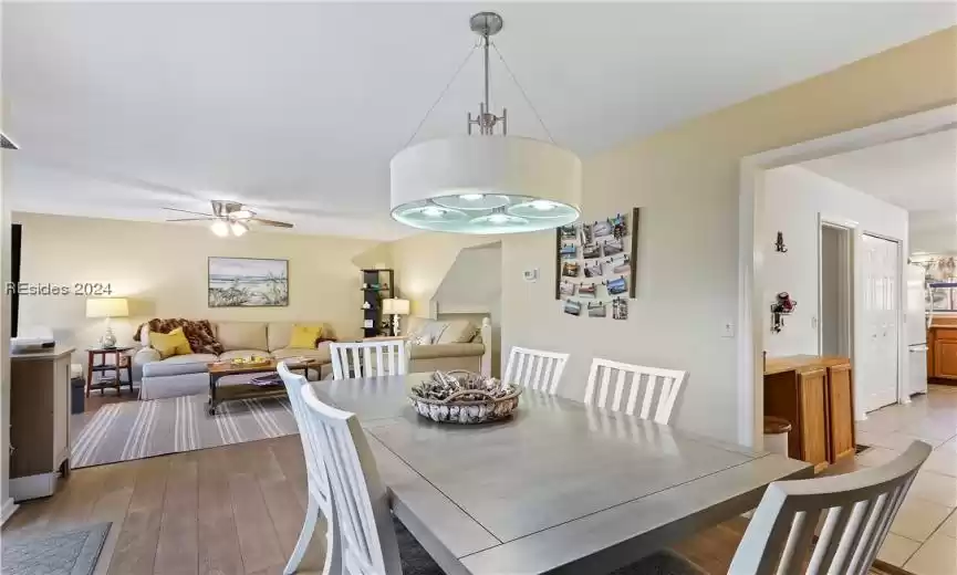 Dining area with light hardwood / wood-style floors and ceiling fan