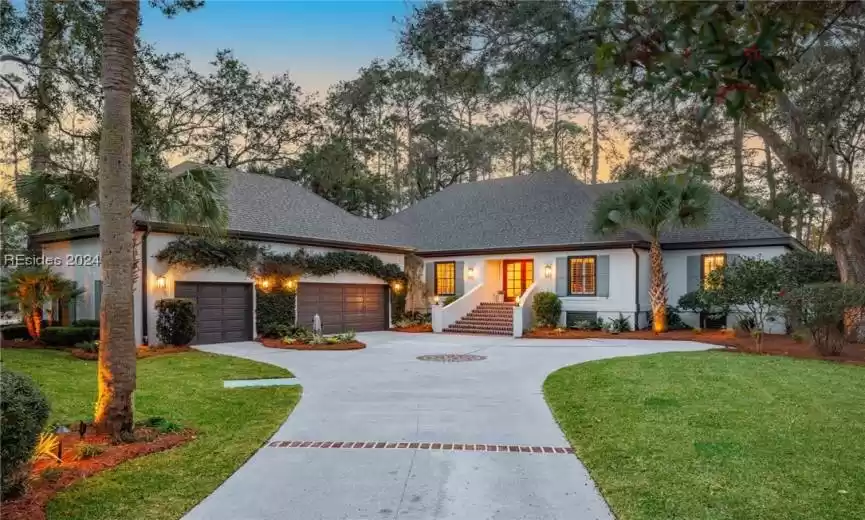 Ranch-style house with a garage and a yard