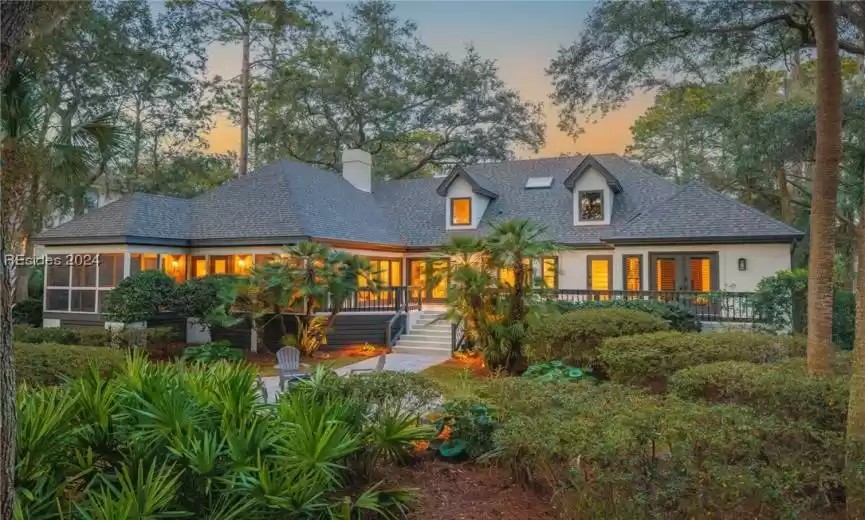 View of the back exterior at dusk. There is room to add a pool on the property