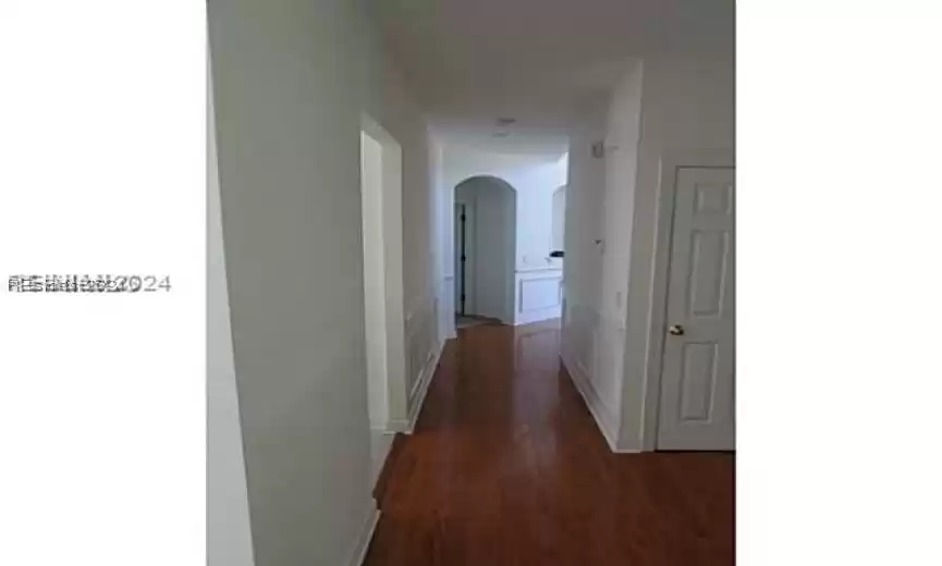 Corridor featuring dark hardwood / wood-style flooring