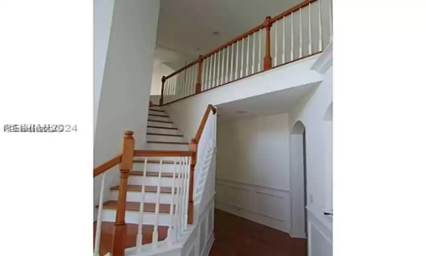 Staircase featuring dark wood-type flooring