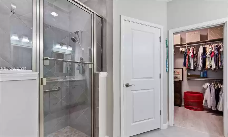 Bathroom with an enclosed shower and hardwood / wood-style flooring