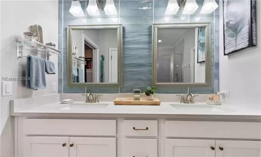 Bathroom with dual bowl vanity and walk in shower