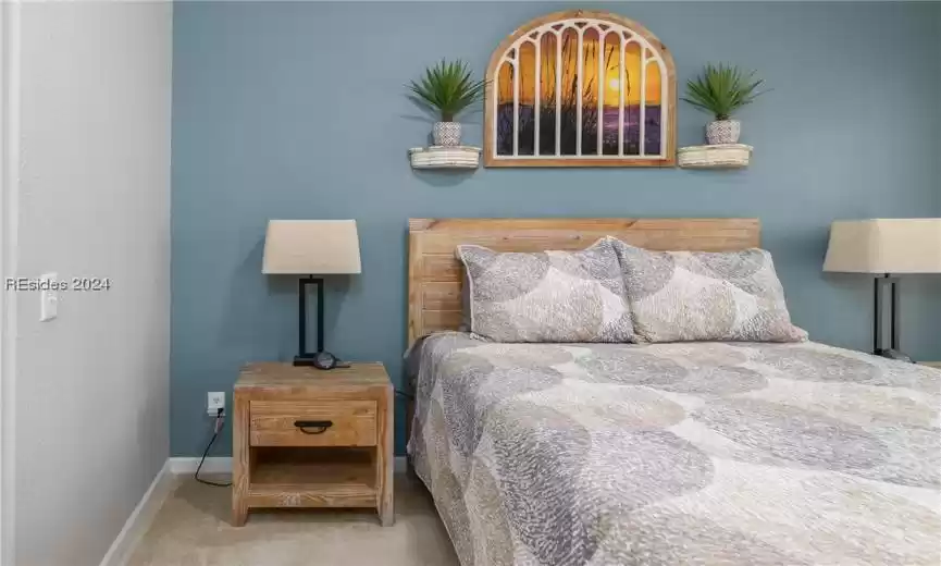 Bedroom featuring light colored carpet