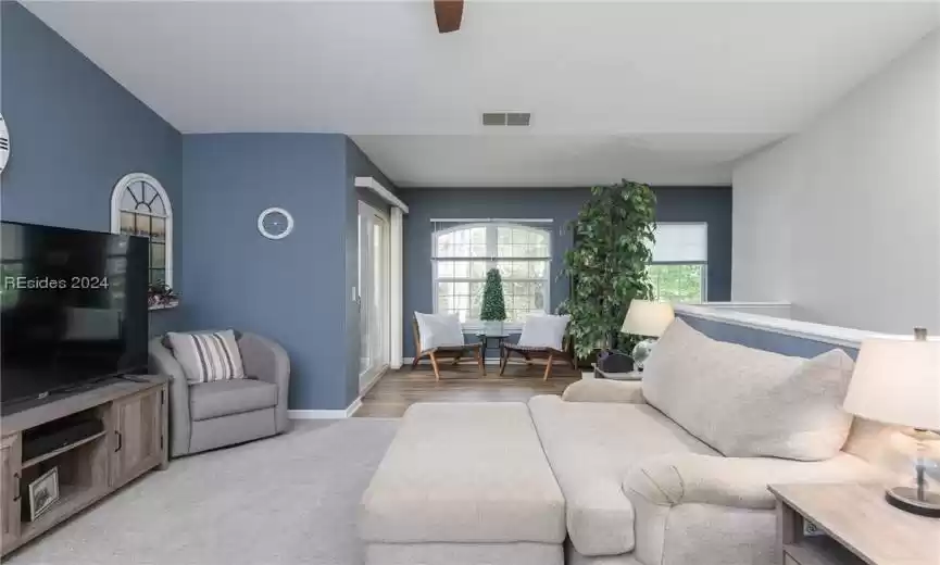 Living room with light wood-type flooring and ceiling fan