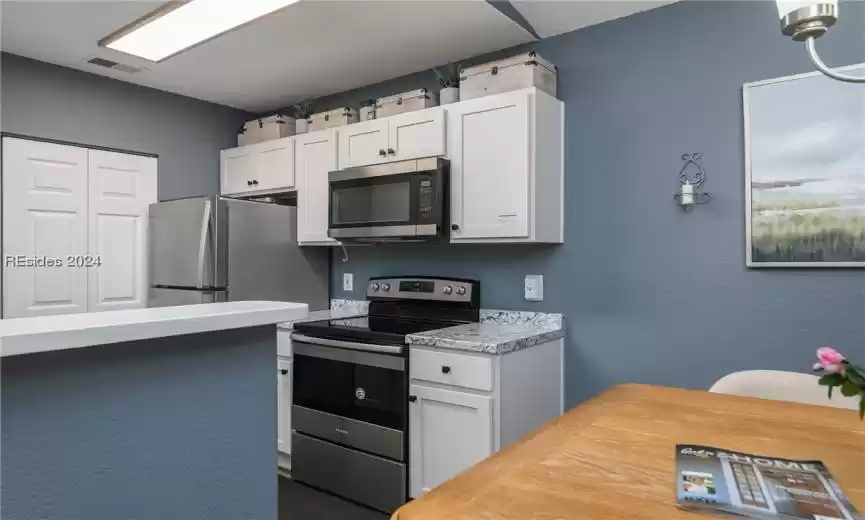 Kitchen with stainless steel appliances and white cabinets