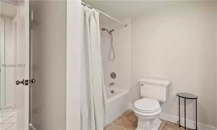 Bathroom with tile floors and tile surround and soaking tub.