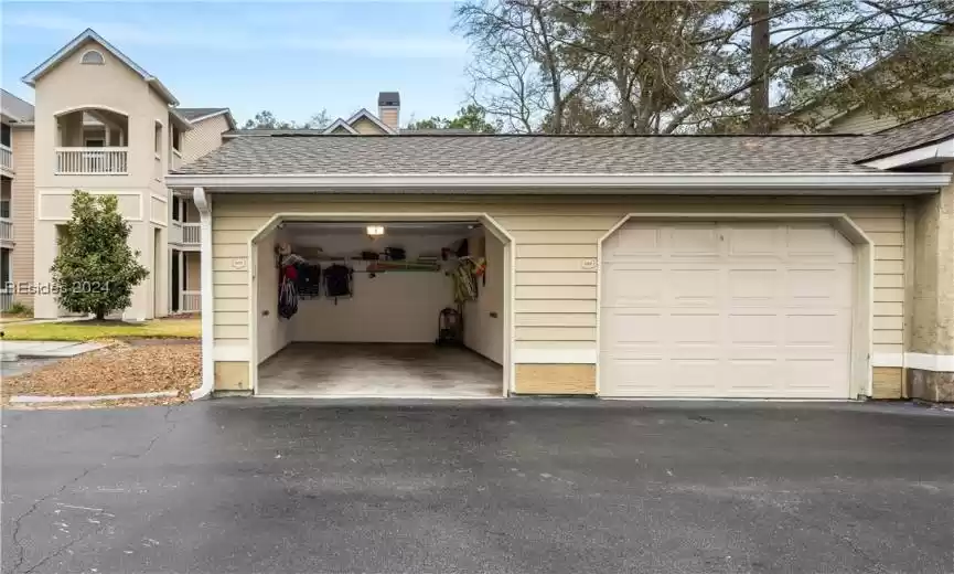 Inside of the garage - lots of storage racks and space inside. New roof on garage and Summer House Buildings