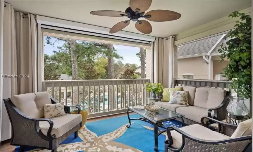 The patio at Summer House Unit F38!  This villa overlooks the beautiful community pool and scenic lagoon! This furnished patio has a remote controlled retractable screen that you can raise and lower with a touch of a button.