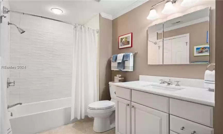 Guest bathroom with new vanity, mirrors, toilet, fixtures and Restoration Hardware pulls and knobs. Again, gorgeous textured tile in shower and as flooring.