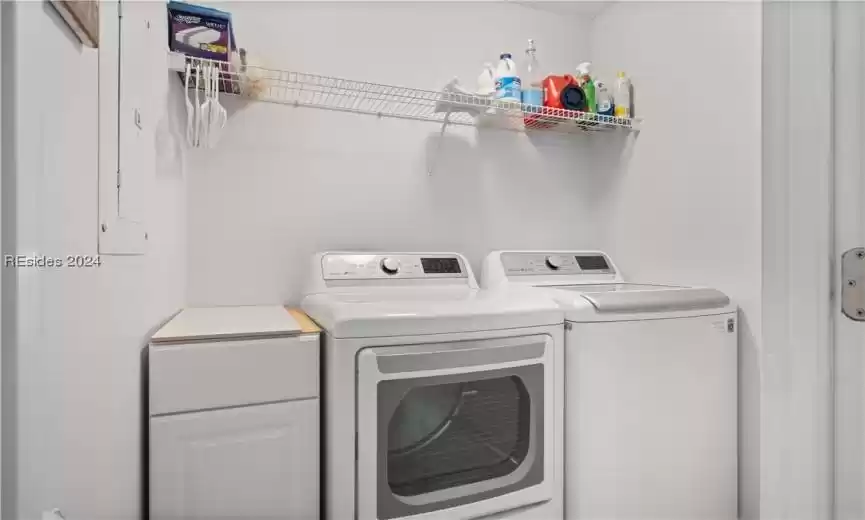 Laundry room  with cabinets and storage area.