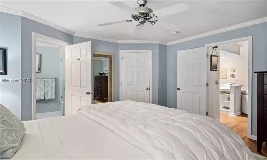 Another view from the primary showing the view into the main living area, the walk in closet and the ensuite bathroom.