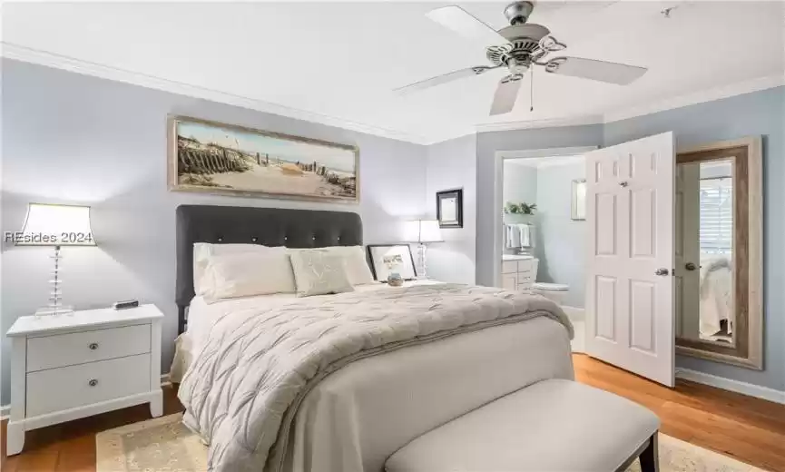 Spacious primary bedroom with crown molding and entry into the ensuite.