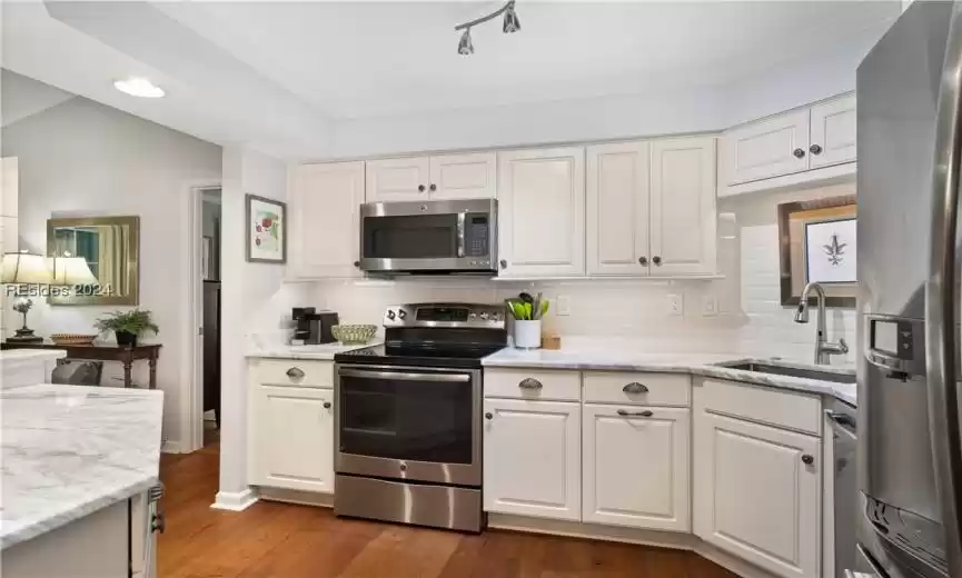 Gorgeous tilework throughout this kitchen with undermount stainless sink.