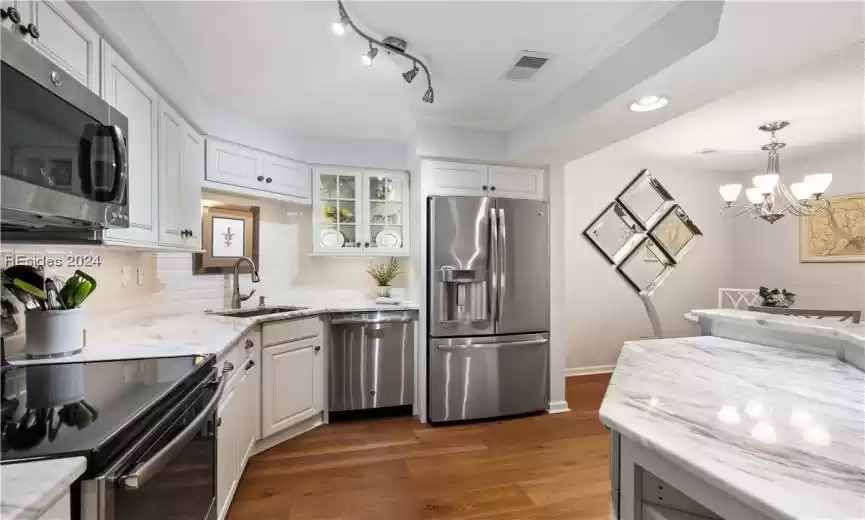 This high end kitchen has luxury written all over it. Look at the reflections off of the marble countertops and the stainless appliances!