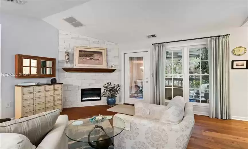 Another view showcasing the gorgeous stonework and mantle with the sleek electric fireplace. All furniture stays.