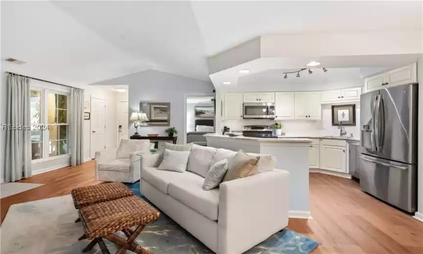 Spacious living room with great access to the kitchen- great recessed lighting on the bar and undercounter lighting was added with the kitchen re-design.