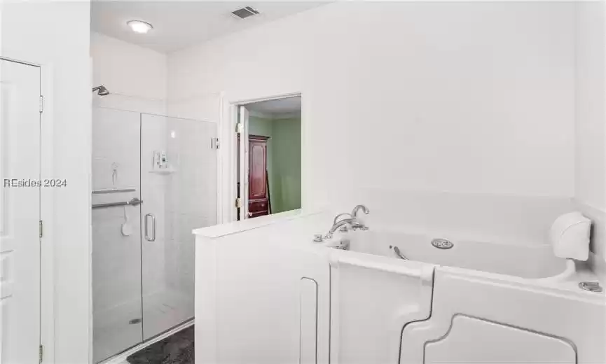 Primary bathroom with jetted walk in bath