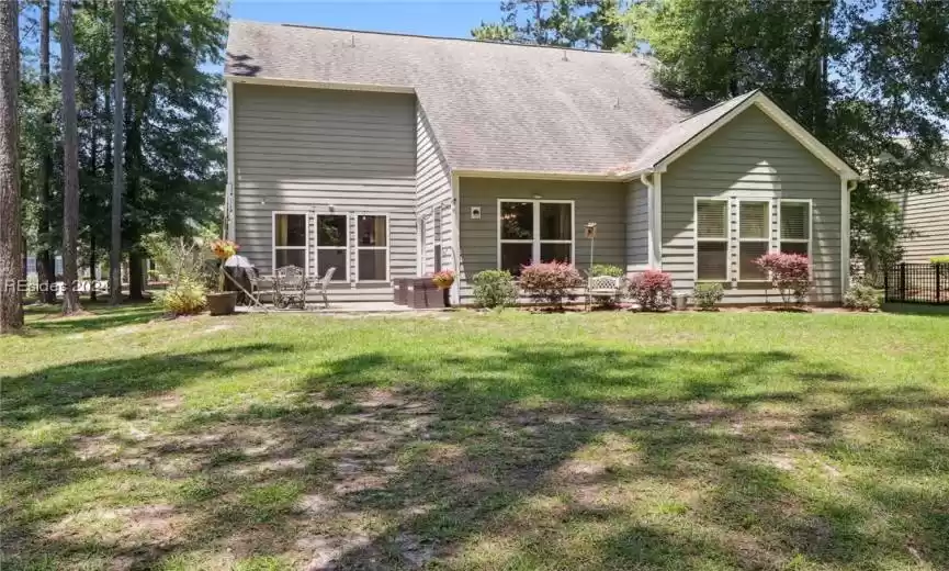 Back of house with a lawn