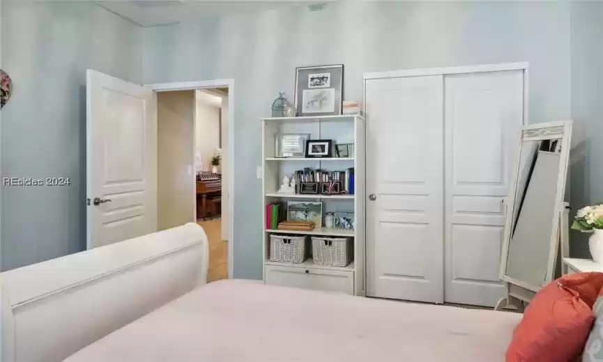 Bedroom with light tile flooring and a closet