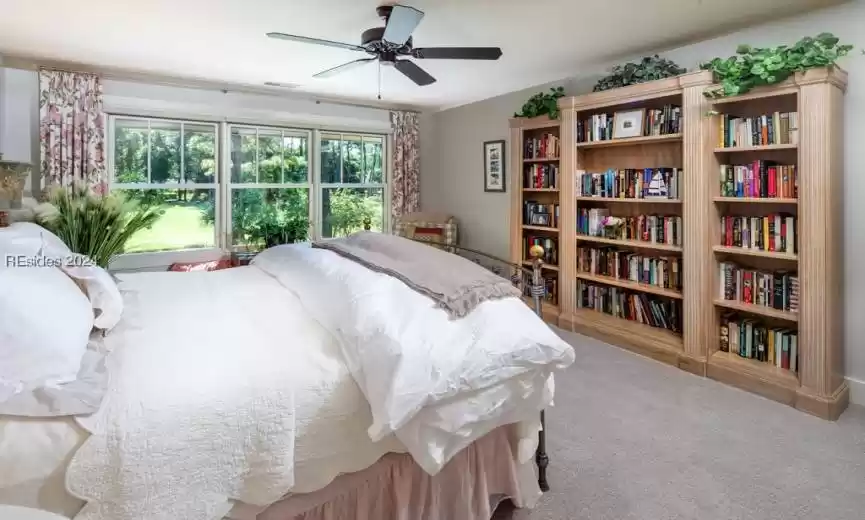Guest Bedroom with light colored carpet and ceiling fan.