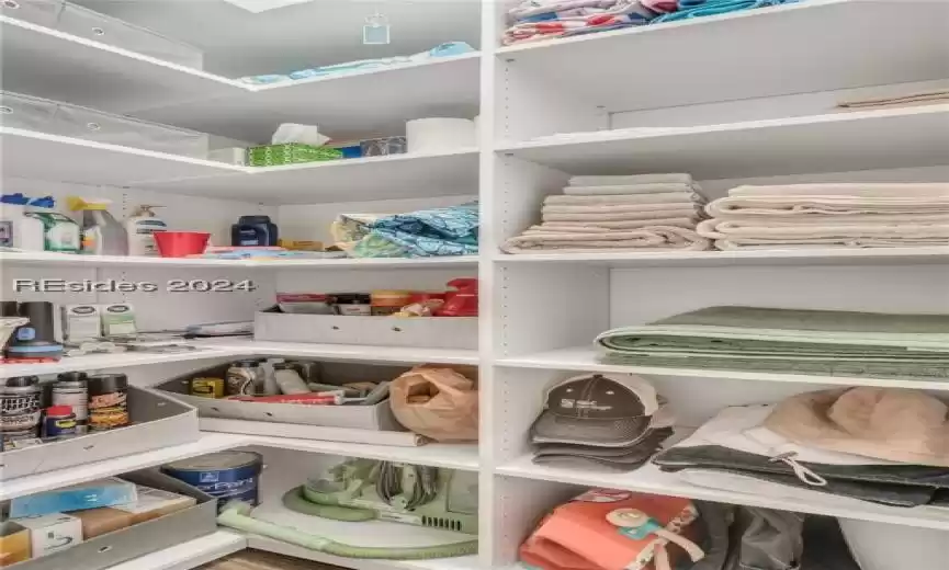 Owner's closet in the hallway with ample storage.