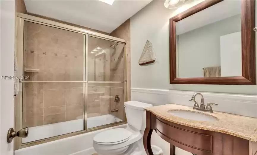 Second bathroom with decorative sink and mirror.