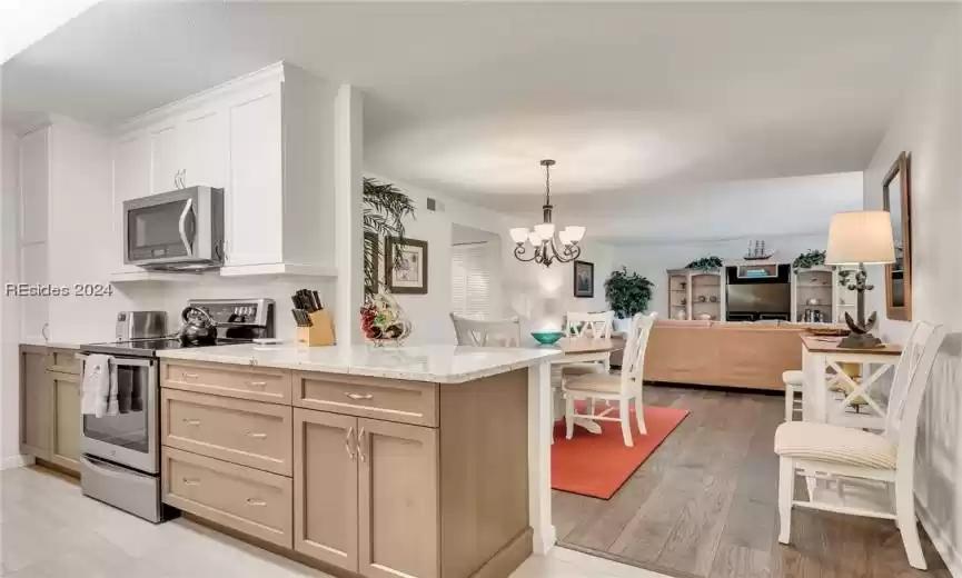 Long view as you enter the villa. Note how the kitchen overlooks the dining space and living room. Great for entertaining.