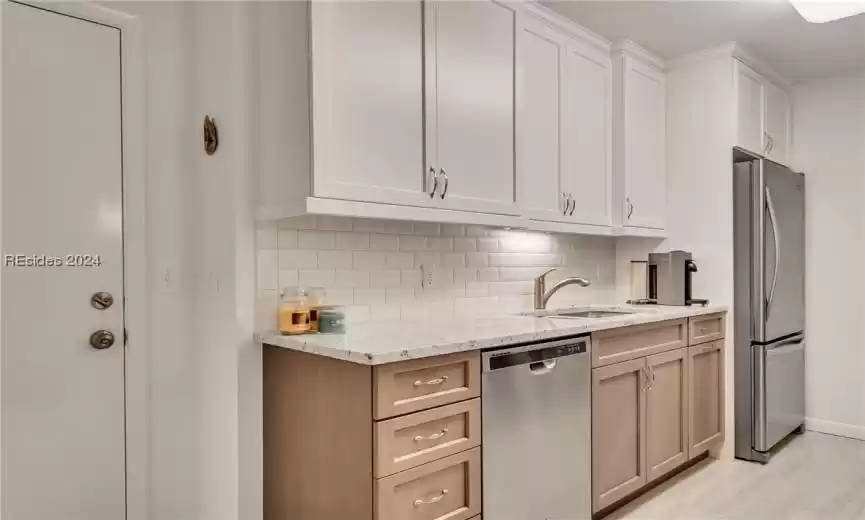 Elegant kitchen boasting granite countertops, subway tile backsplash and stainless appliances.