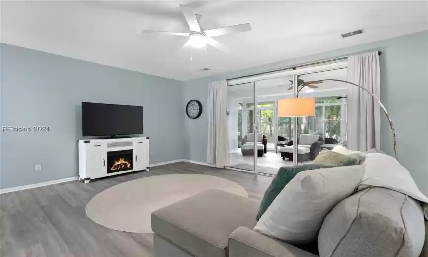 Living room featuring ceiling fan and wood-type flooring