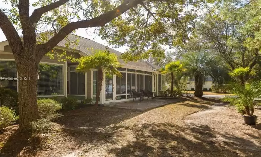 Rear view of property featuring a sunroom