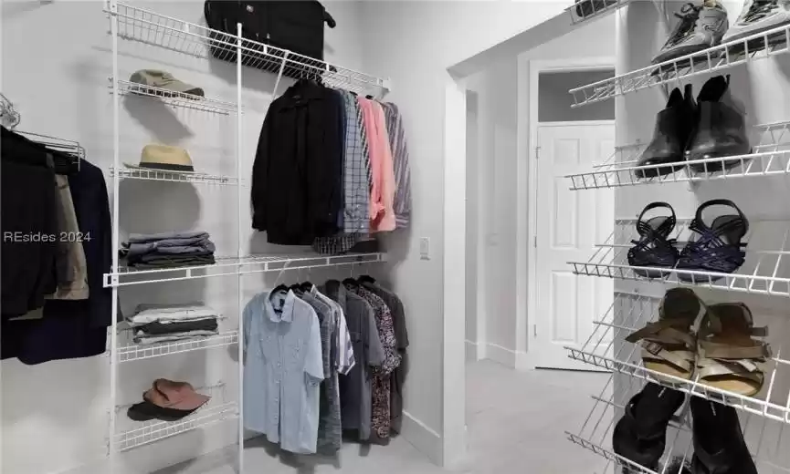 Spacious closet with light tile floors