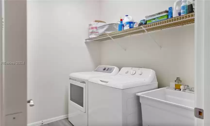Clothes washing area with washer and clothes dryer and sink
