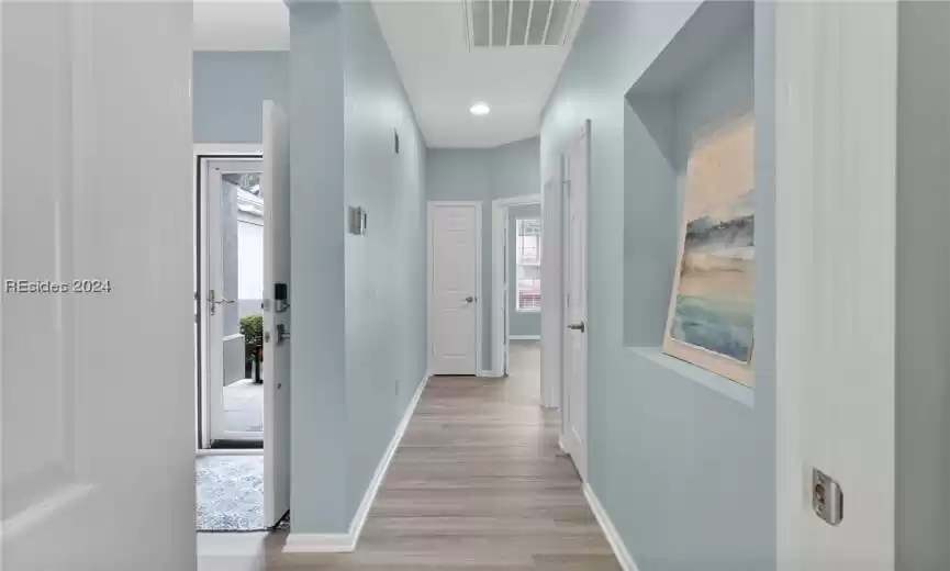 Corridor with light wood-type flooring