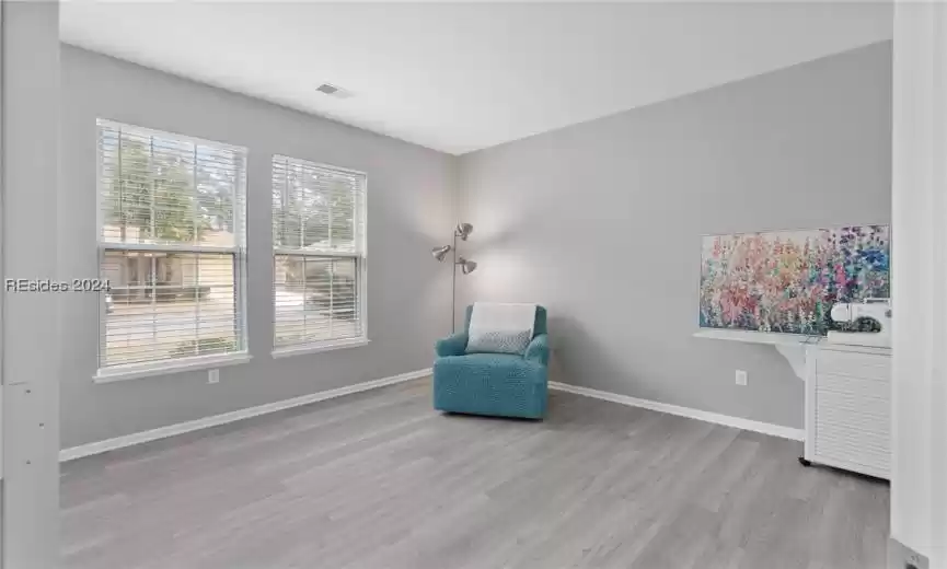 Living area with light hardwood / wood-style floors and a healthy amount of sunlight