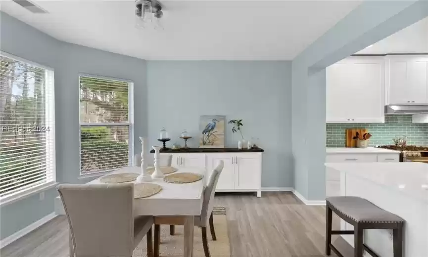 Dining area with plenty of natural light and light hardwood / wood-style flooring