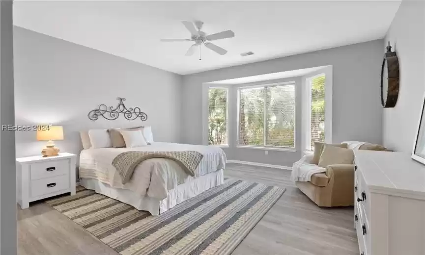 Bedroom featuring light hardwood / wood-style flooring and ceiling fan