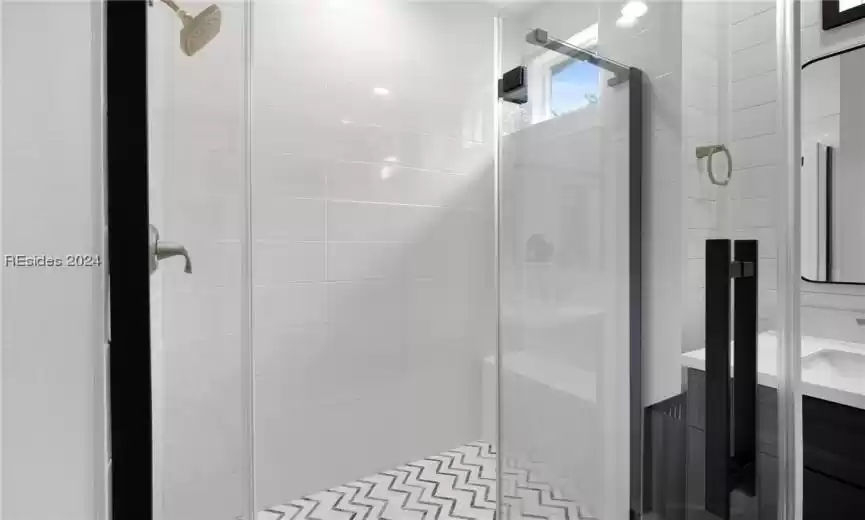 Bathroom with vanity and a shower with shower door