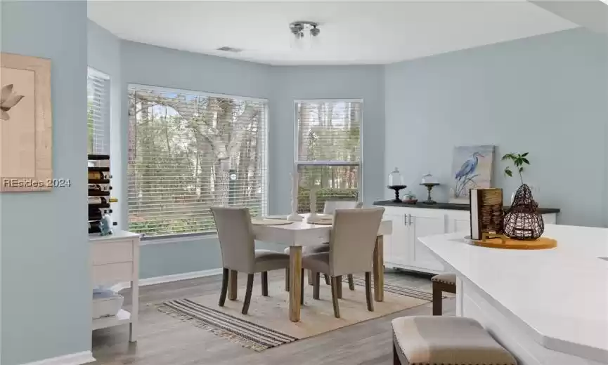 Dining room featuring light hardwood / wood-style flooring and a healthy amount of sunlight