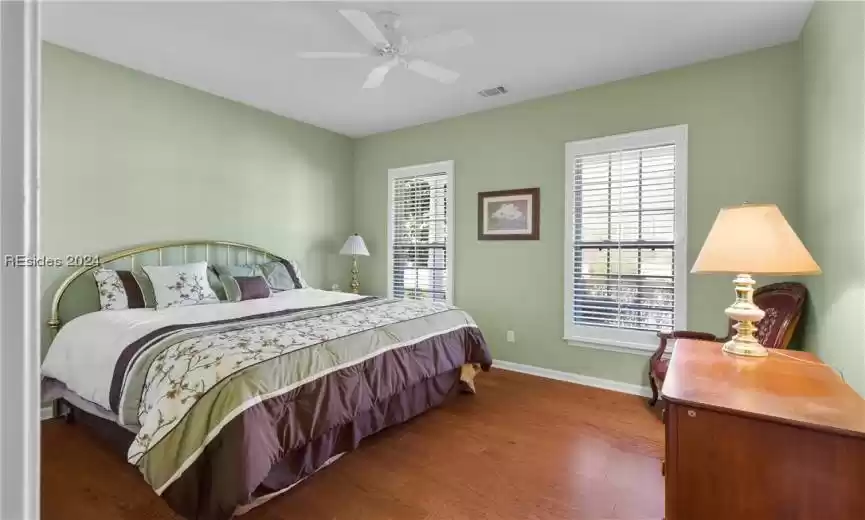 Bedroom featuring dark hardwood / wood-style flooring and ceiling fan