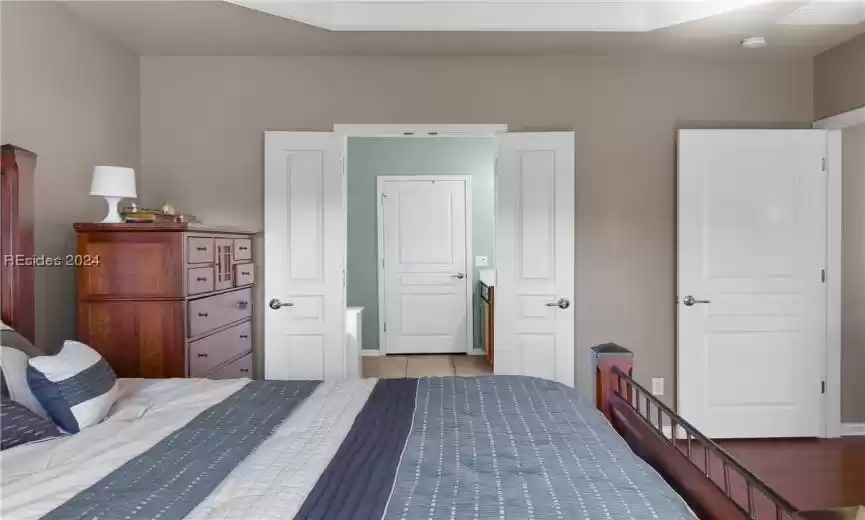 Bedroom with dark hardwood / wood-style flooring