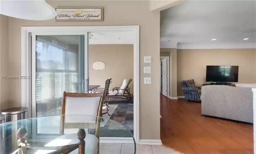 Dining area featuring crown molding, ceiling fan, and light wood-type flooring