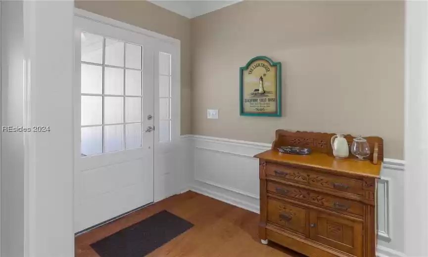 Entrance foyer featuring plenty of natural light and dark wood-type flooring