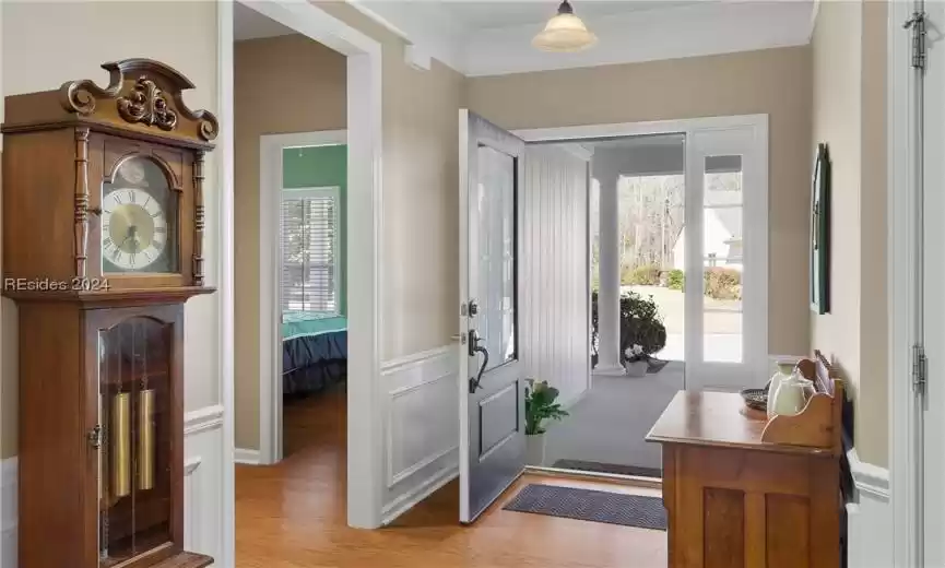 Foyer entrance featuring plenty of natural light, light hardwood / wood-style flooring, and ornamental molding