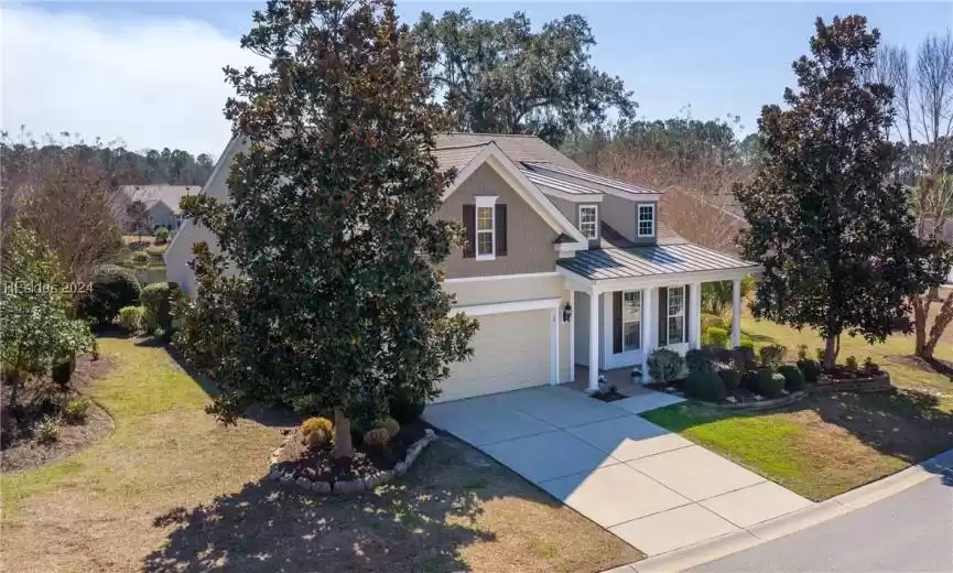 View of front of property featuring a front lawn and a garage