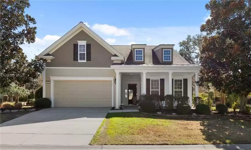 View of front facade featuring a garage and a porch